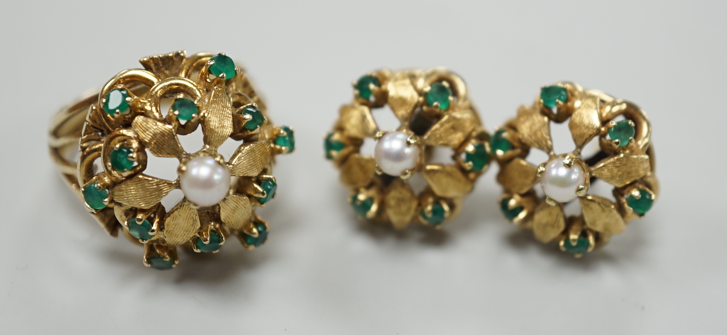 A modern continental, cultured pearl and green stone cluster set dress ring, size N, and a pair of matching earrings, one butterfly missing, gross weight 15 grams.